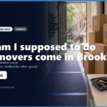 What Am I Supposed to Do When Movers Come in Brooklyn? Moving day preparation scene in Brooklyn, featuring stacked moving boxes, packing blankets, and a smartphone on a table. The image illustrates what to expect when movers arrive, complemented by contact information for a local moving service.